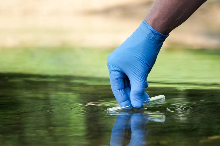 Test tube being filled with a water sample - aquatic management by Sorko Services in Central Florida