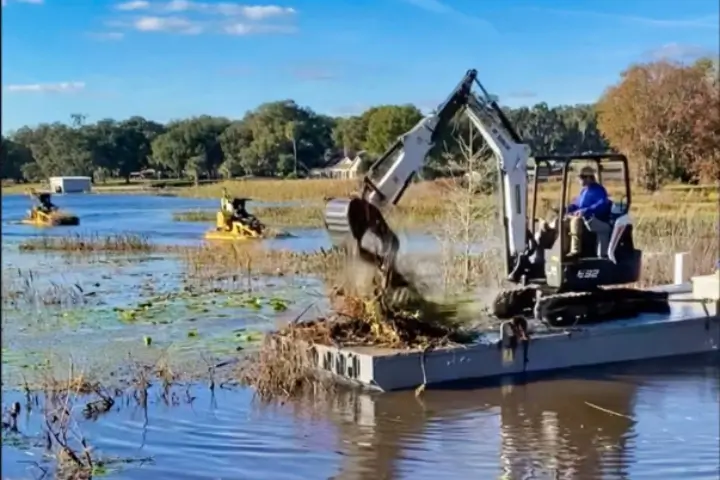 Workers digging out debris in pond - Irrigation Specialist Sorko Services in Pest Control & Exterminators | Pond and Lake Management Experts Sorko Services in Sanford, FL